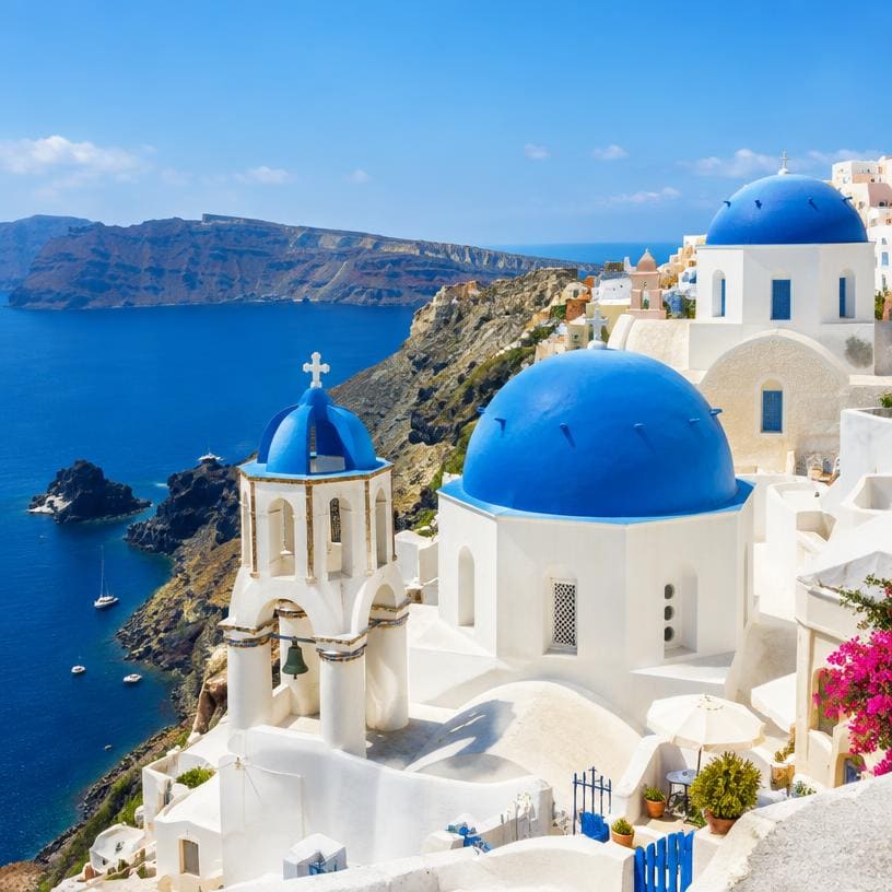 White buildings with blue domes above the sea in Greece